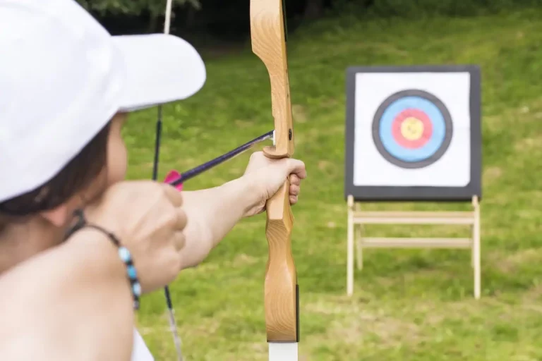 young-female-archer-holding-his-bow-aiming-target-sport-recreation-concept_181624-50254